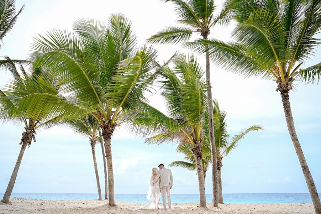 Bride and groom standing on a beach