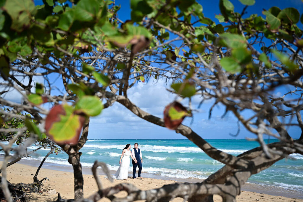 Bride and groom walking on the beach