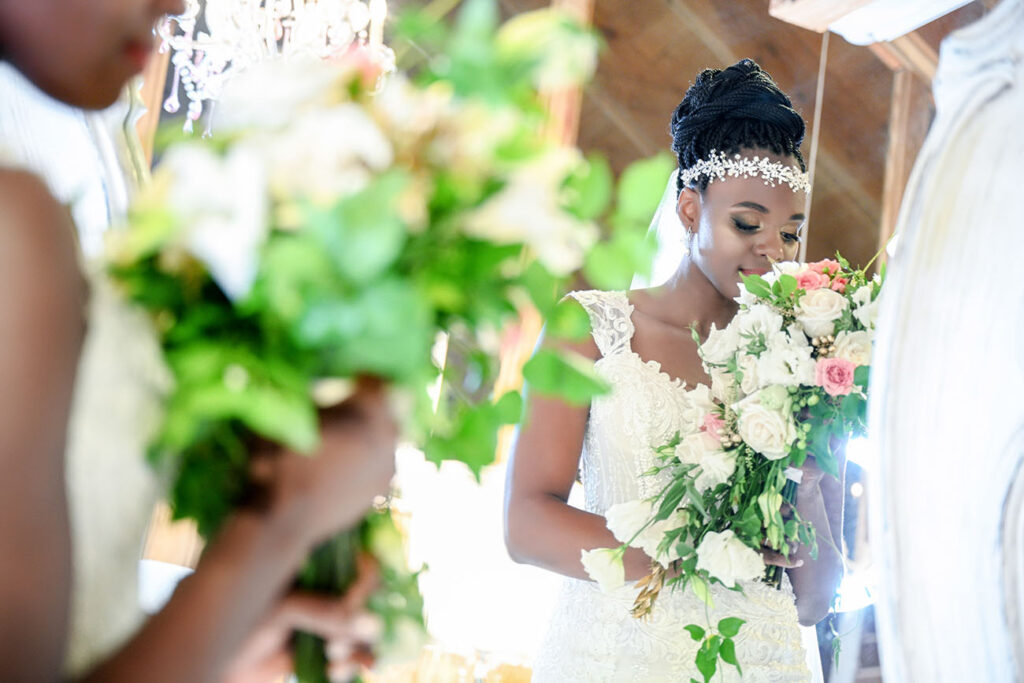 Bride in wedding dress smelling wedding bouquet