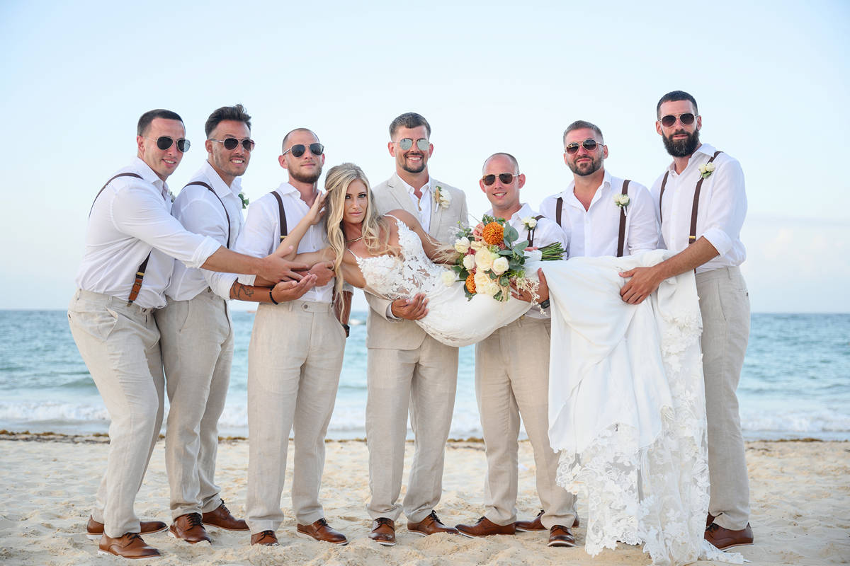groomsmen holding bride