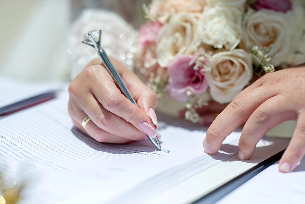 signature for the marriage certificate with brides flowers
