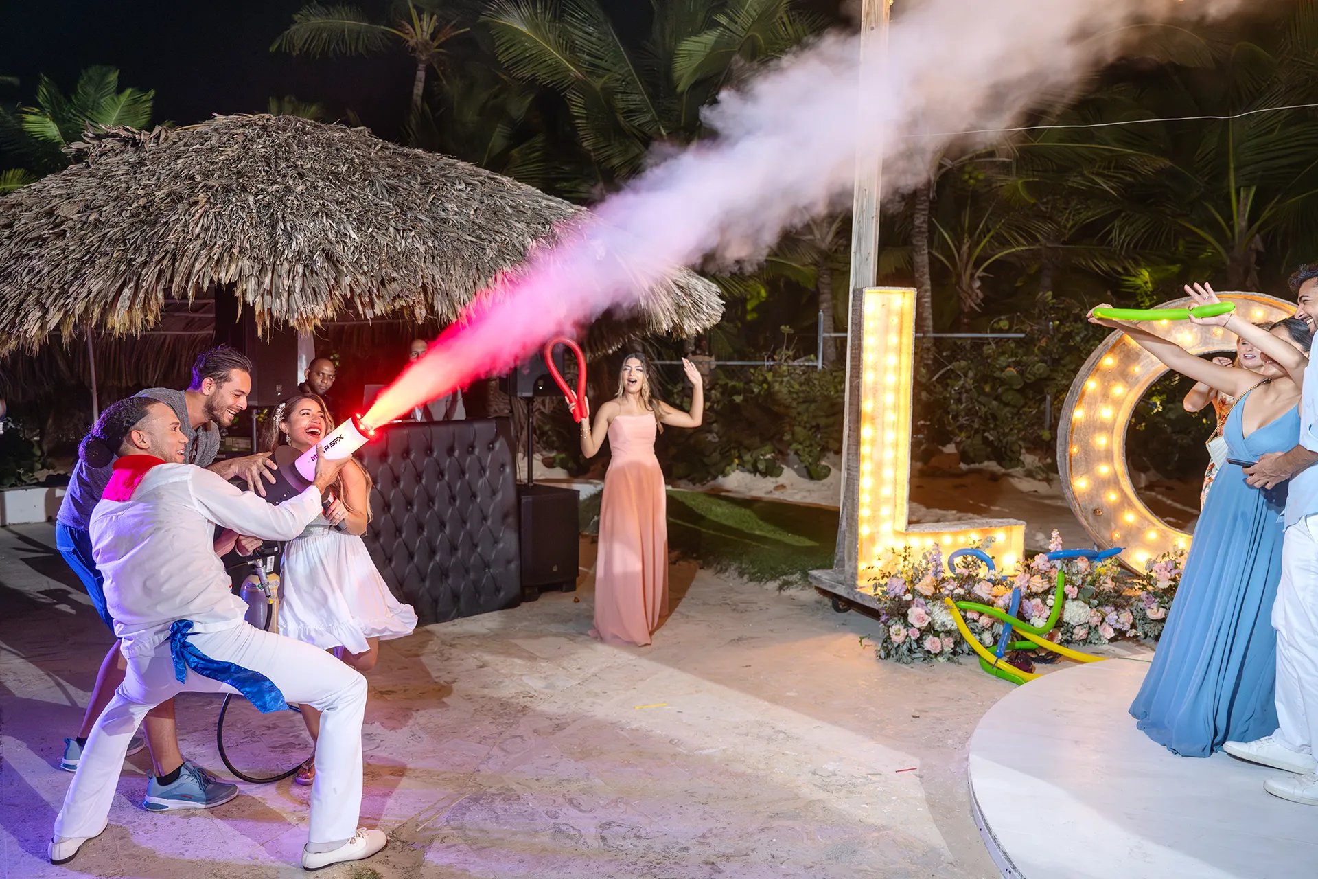 Cassandra and Matthew dancing in front of illuminated LOVE letters at Kukua Cassandra and Matthew dancing in front of illuminated LOVE letters at Kukua