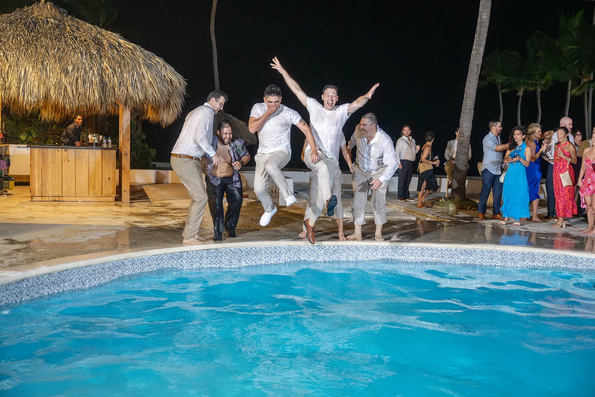 Matthew and his friends jumping into the Kukua pool at the end of the wedding