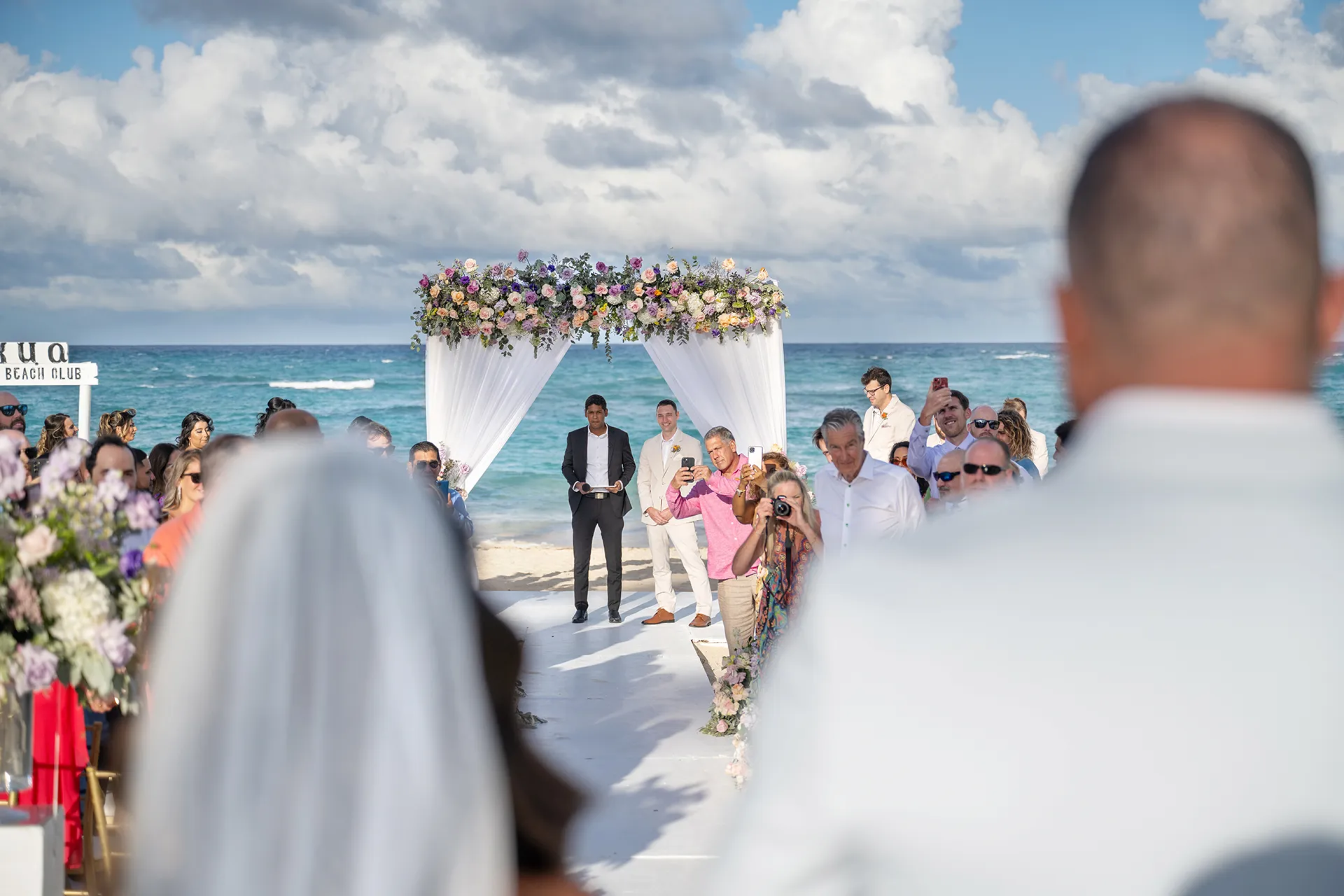 Cassandra walking toward her Kukua beach ceremony with her father Cassandra walking toward her Kukua beach ceremony with her father