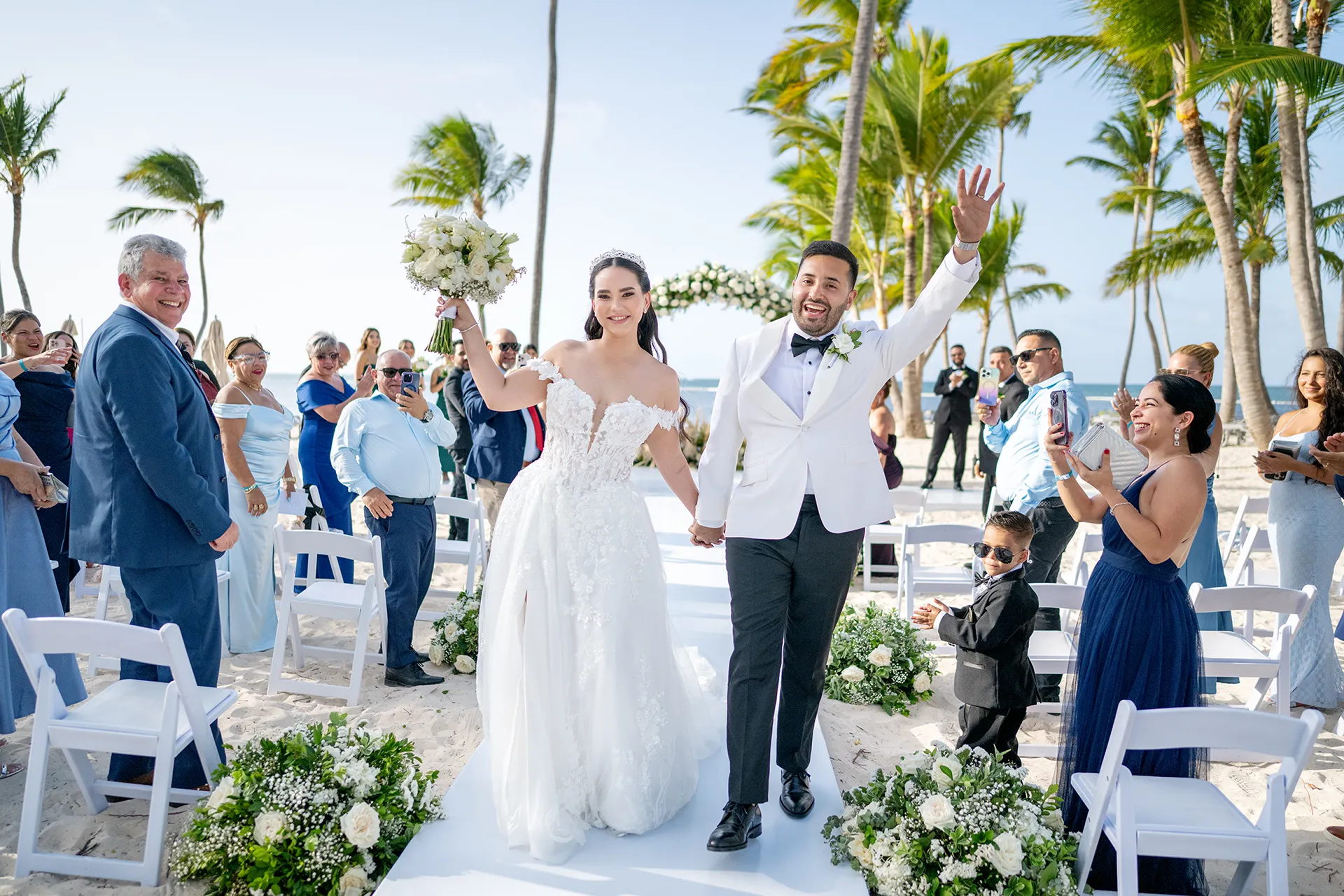 Bride and groom walking down the aisle after oceanfront wedding ceremony at Pearl Beach Club Bride and groom walking down the aisle after oceanfront wedding ceremony at Pearl Beach Club
