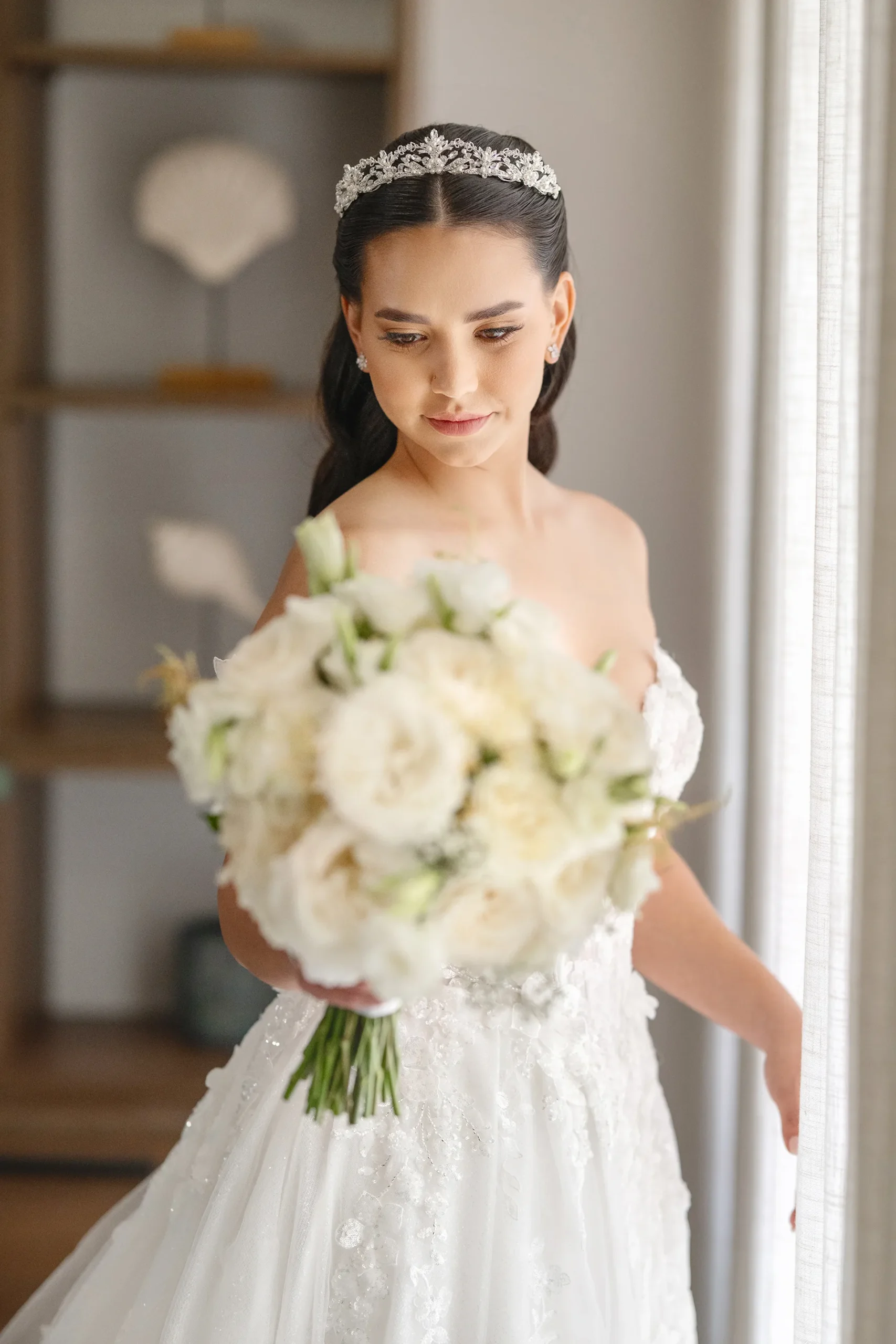 Beautiful bride holding a white rose bouquet at Pearl Beach Club Punta Cana Beautiful bride holding a white rose bouquet at Pearl Beach Club Punta Cana