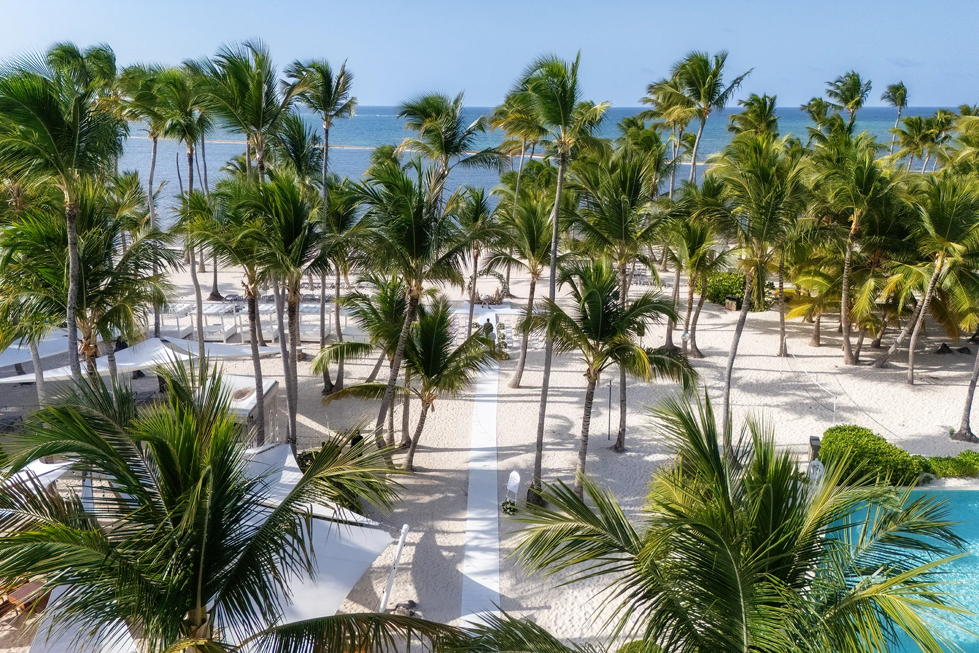 Aerial daytime view of beach wedding ceremony setup at Pearl Beach Club Punta Cana Aerial daytime view of beach wedding ceremony setup at Pearl Beach Club Punta Cana
