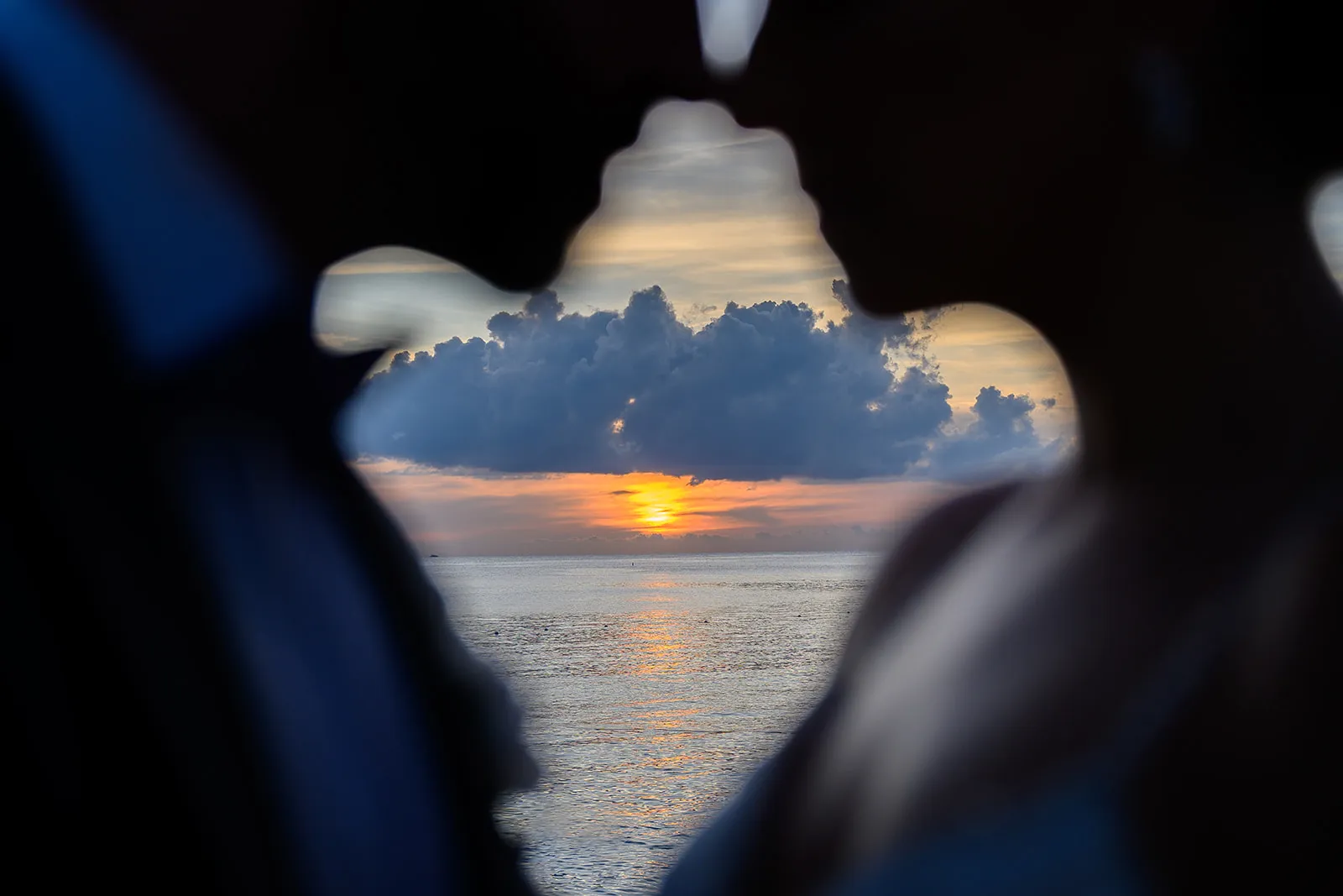 Silhouette of a couple against a Caribbean sunset during a Punta Cana post-wedding photo shoot