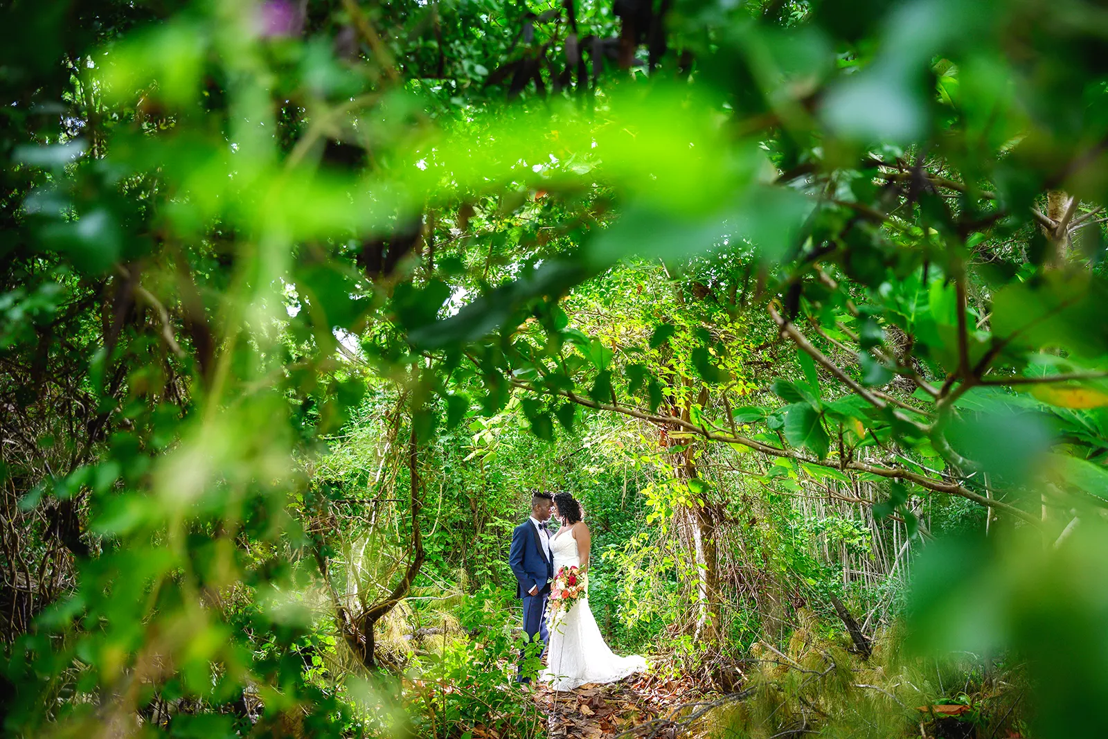 Bride and groom surrounded by lush green jungle at Caño Hondo in the Dominican Republic