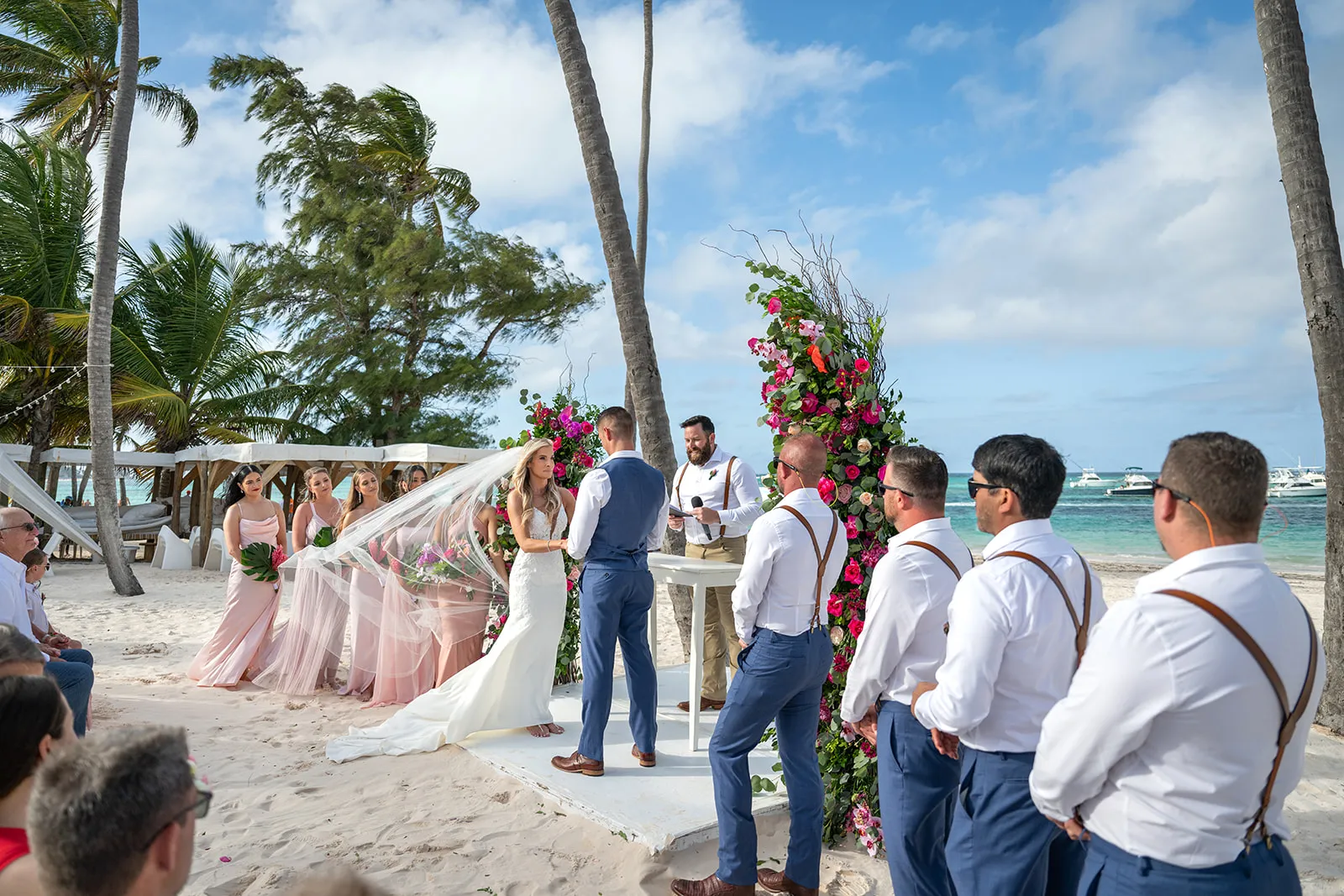 Bride and groom exchanging vows on the sand in front of Jellyfish Restaurant Punta Cana