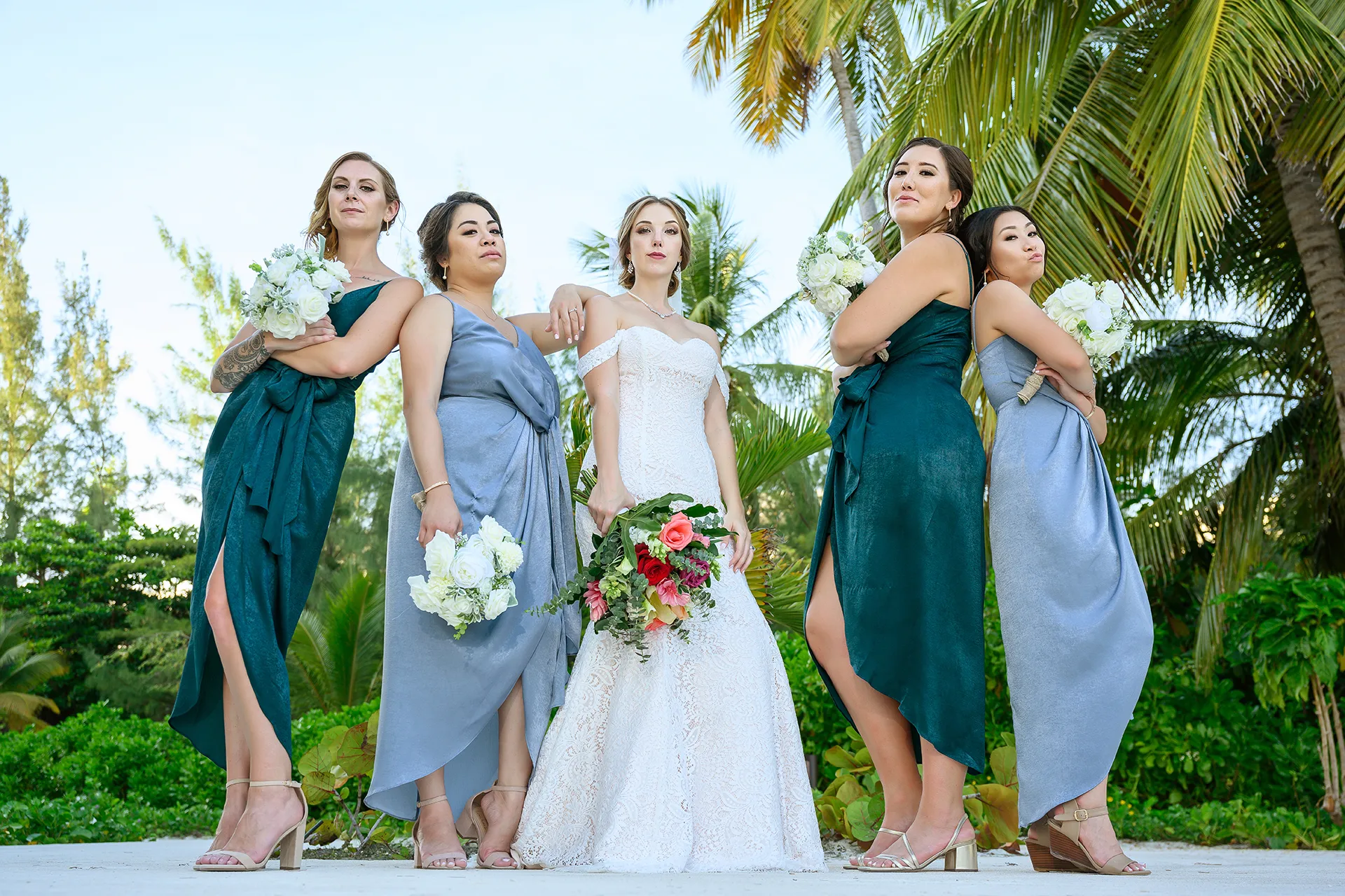 beach-wedding-bridesmaid-dresses-shoes-punta-cana Bride with bridesmaids in teal and dusty blue dresses wearing block heels and wedges in Punta Cana