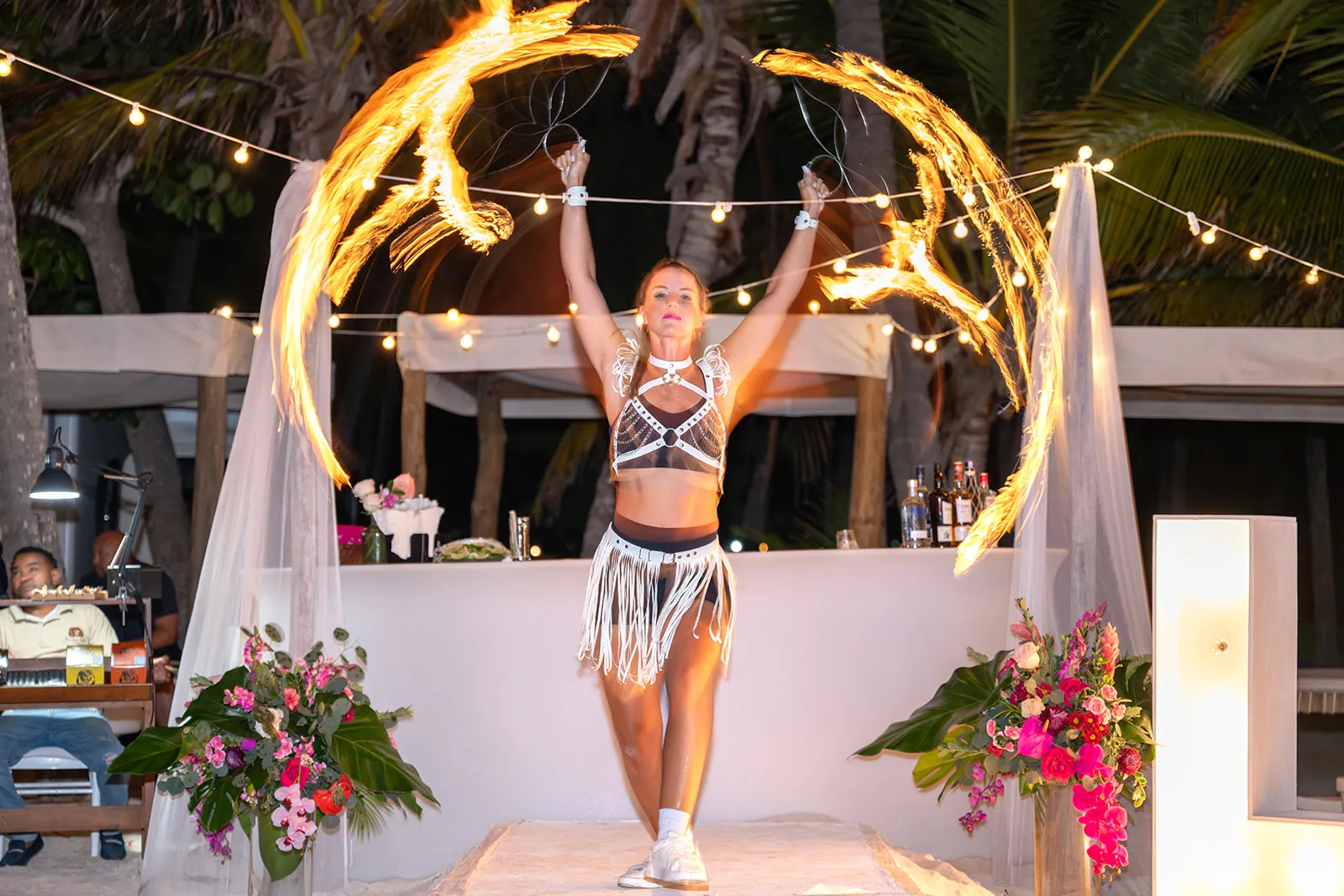 Fire dancer performing beside the reception at a Jellyfish Restaurant Punta Cana wedding