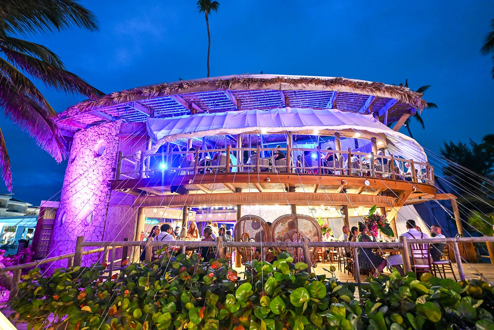 jellyfish restaurant punta cana wedding venue night Jellyfish Restaurant Punta Cana lit in purple and blue during a wedding reception at night