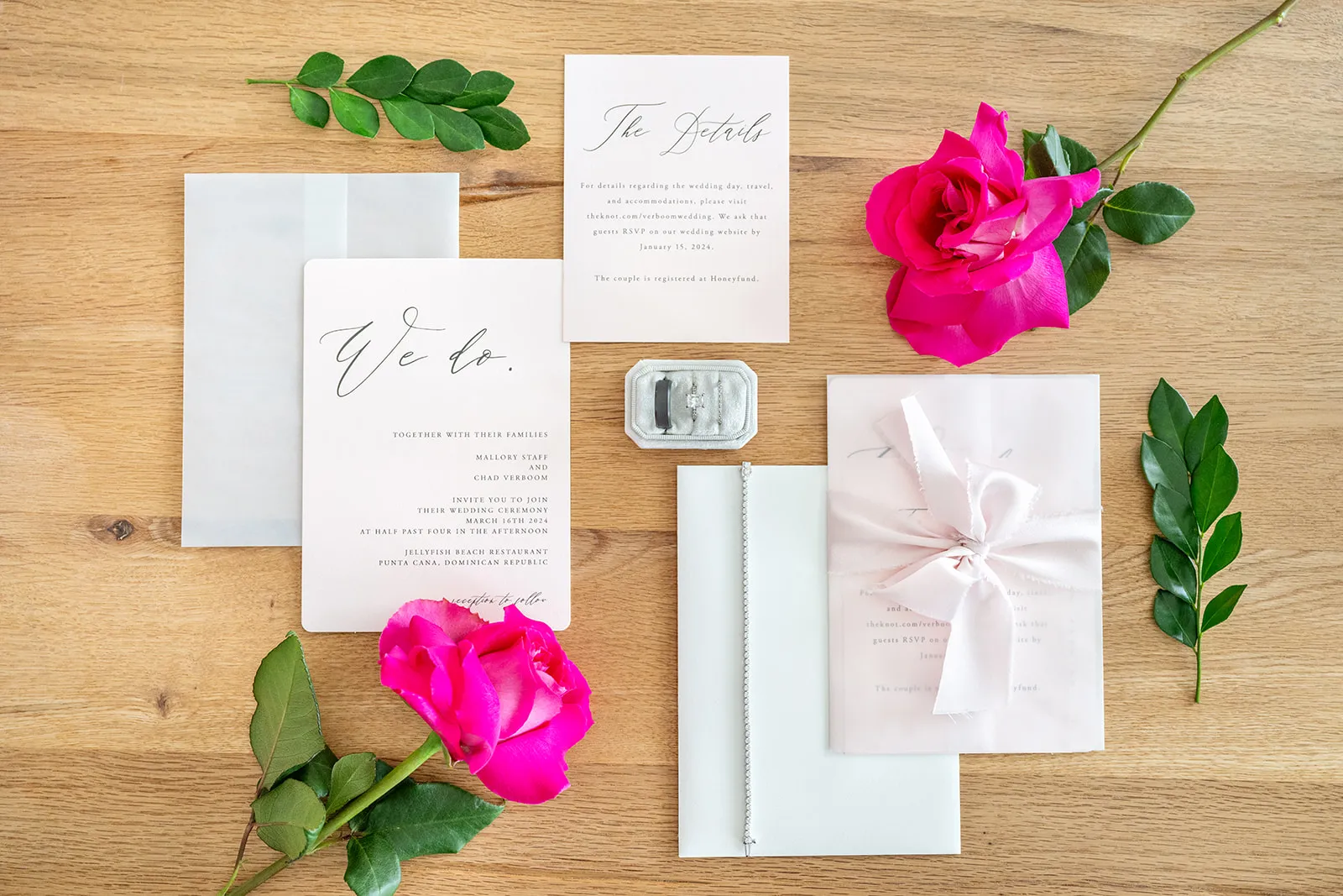 jellyfish wedding invitation details Wedding invitation suite with pink roses and the bride's rings before a Jellyfish Restaurant Punta Cana wedding