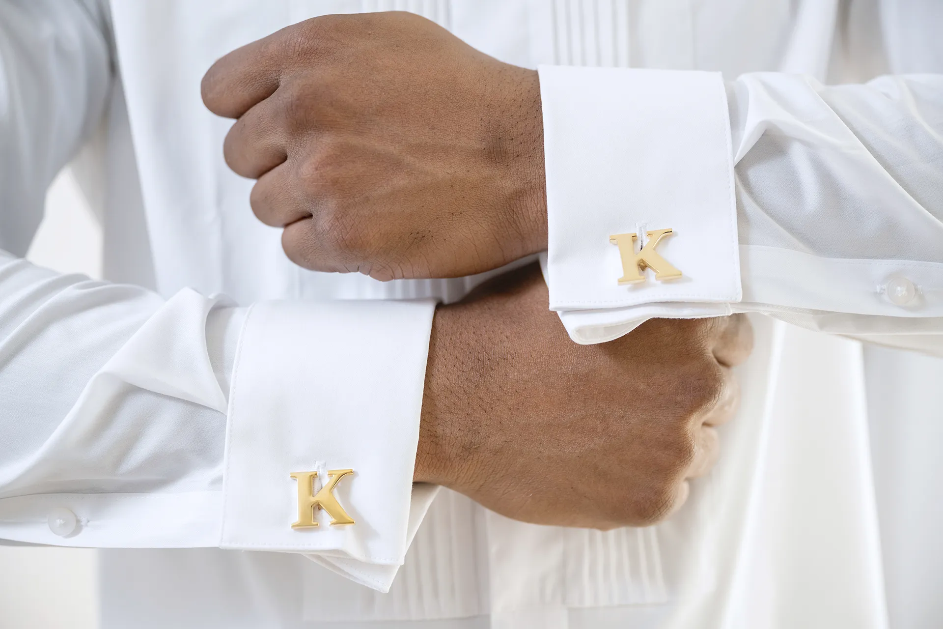 personalized-groom-cufflinks-wedding-details Gold initial cufflinks on the French cuffs of a groom's white pleated shirt