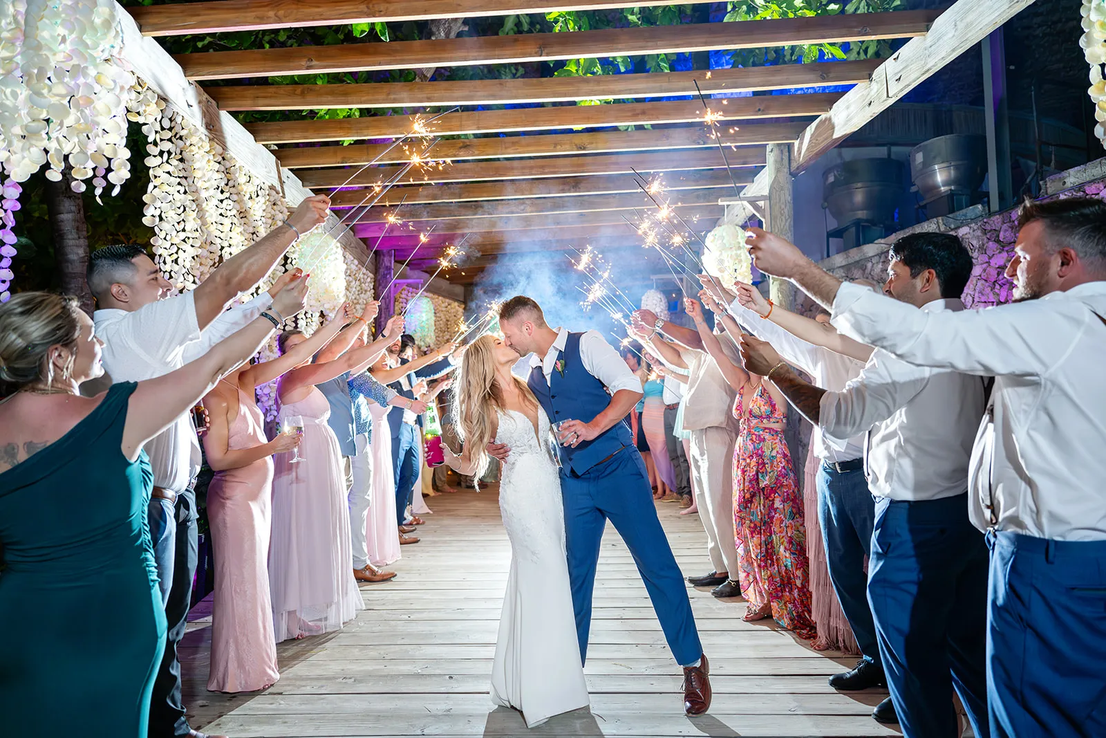 Bride and groom kissing during a sparkler exit at Jellyfish Restaurant Punta Cana