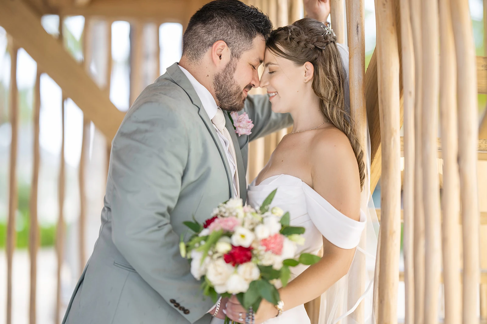 autumn-santiago-dreams-flora-wedding-portrait Bride and groom touching foreheads with eyes closed against a wooden slatted wall at Dreams Flora