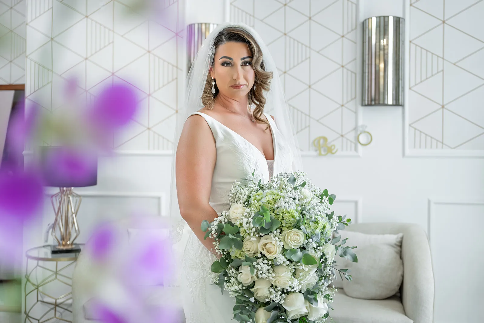 Bridal portrait of Frankeesue holding her white rose and baby's breath bouquet in the Dreams Macao Beach bridal room