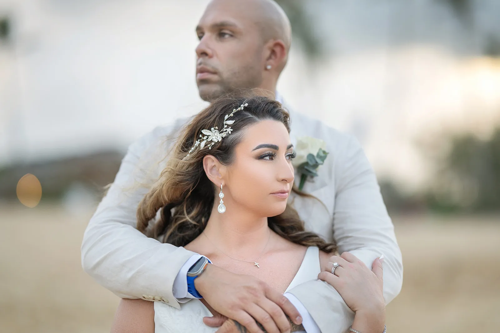 Editorial portrait of Miguel holding Frankeesue from behind after their Dreams Macao Beach ceremony